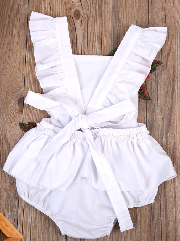 Baby little onesie has big red flower appliques and ties at the back for easy slip-on white