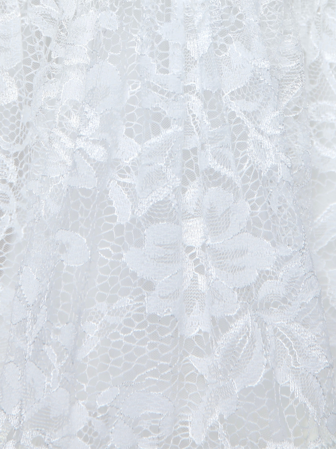 Close up of ivory lace skirt with floral textured pattern
