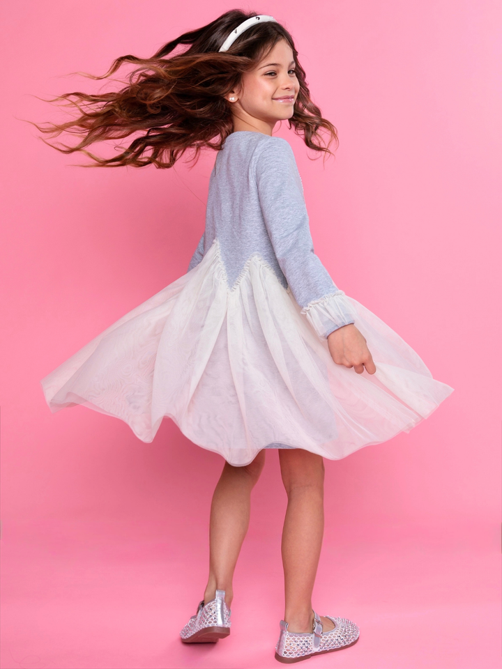 Girls twirling in grey dress with full tulle skirt