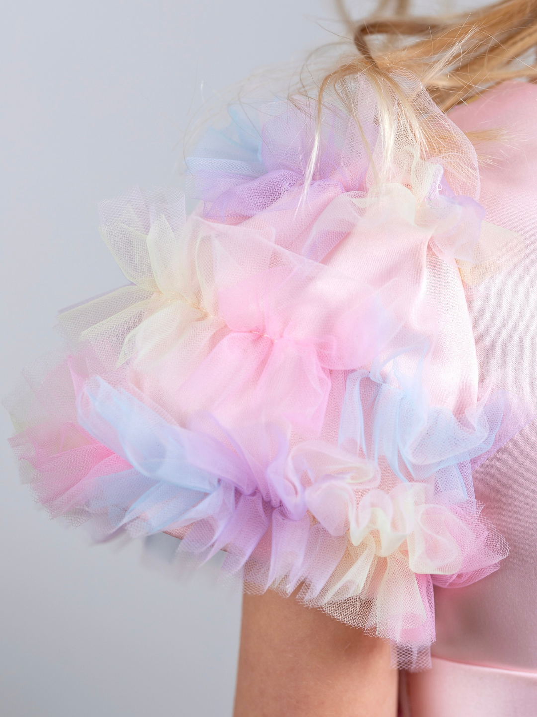 Pastel rainbow tulle flower girl dress with layered high-low skirt and delicate floral accents