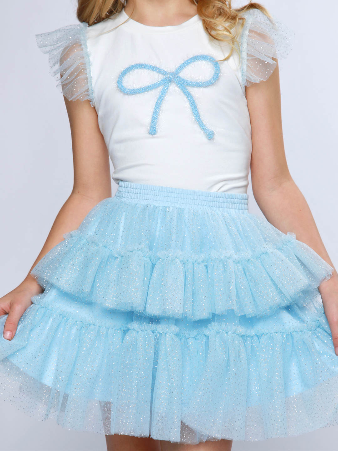 White top with blue bow detail for girls outfit