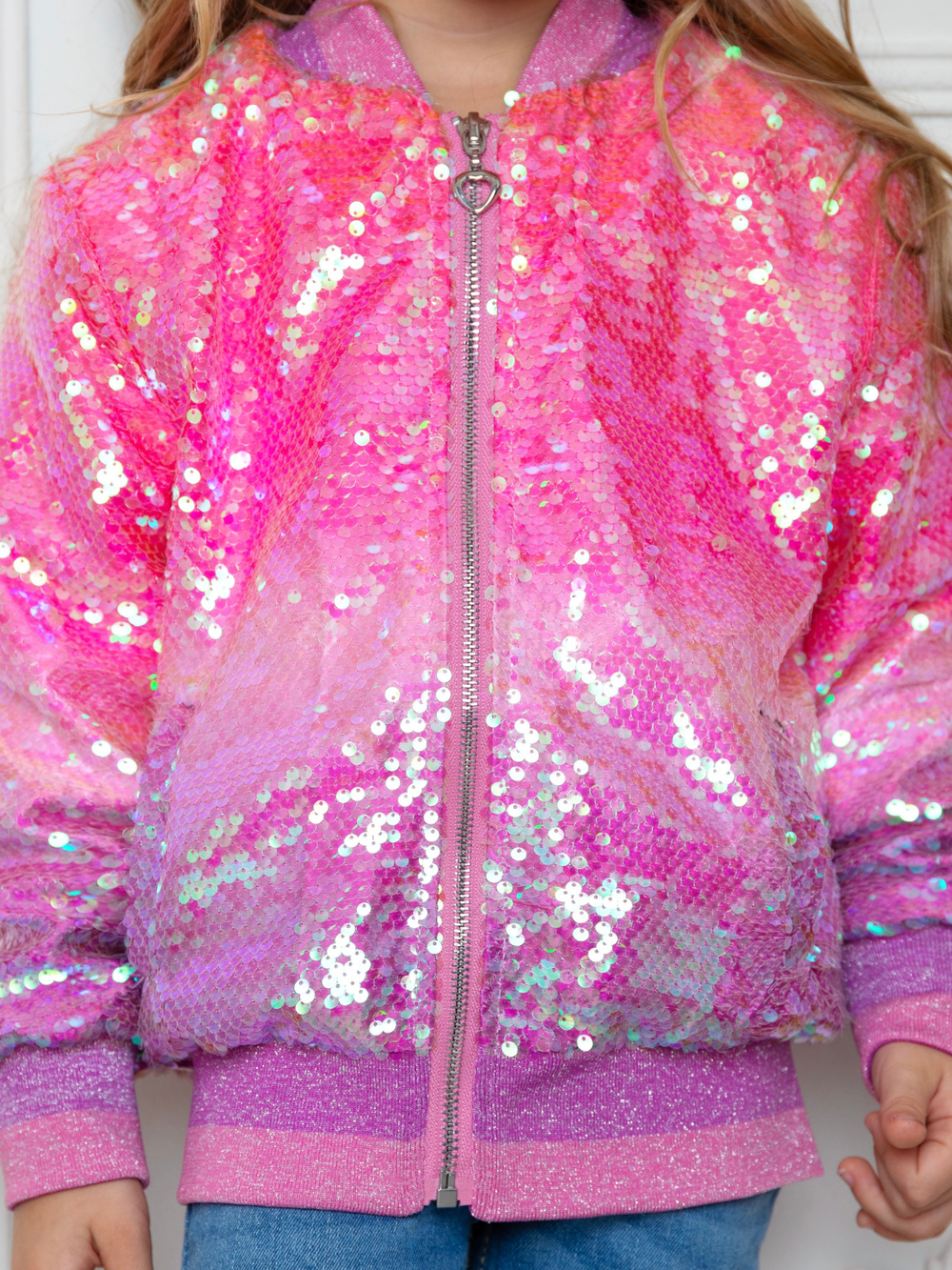 Little girl wearing pink sequin bomber jacket for birthday party outfit
