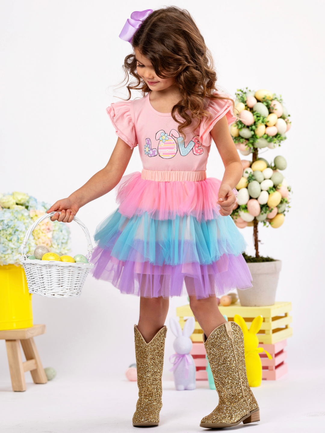 Girl wearing a pastel tiered tulle Easter dress with colorful layers for spring celebrations