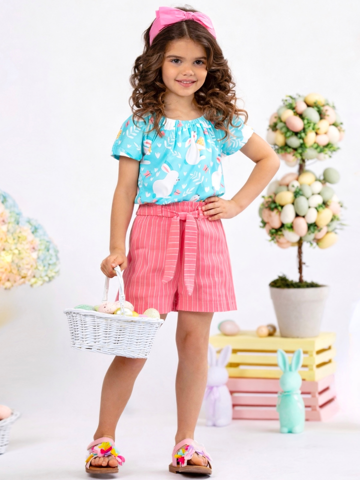 Girl wearing a bunny printed Easter short set with mint top and pink striped shorts