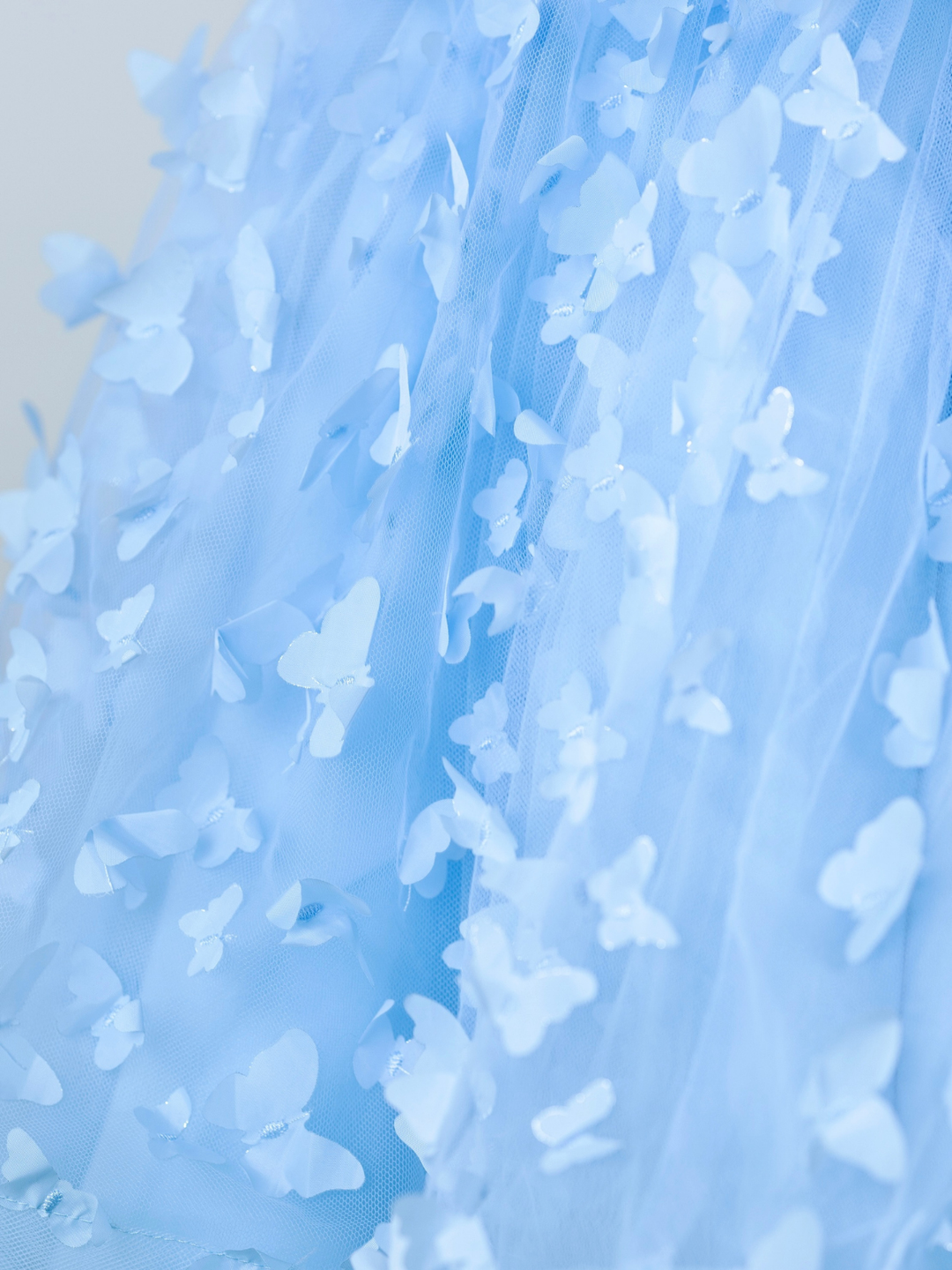 Sheer flutter sleeve detail on girls blue Easter dress