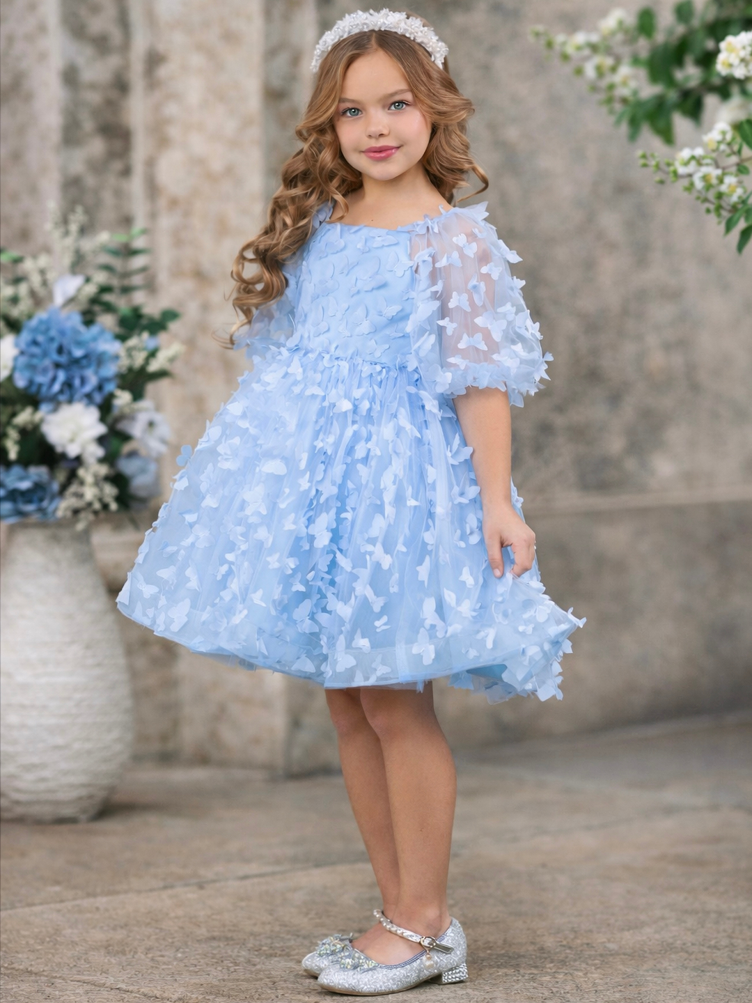 Girls blue butterfly dress styled for spring wedding