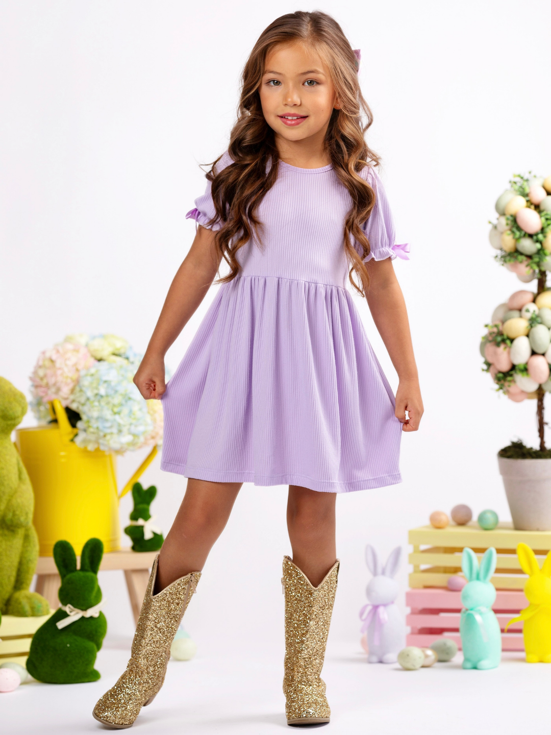 Girl wearing a lavender ribbed Easter dress with bow sleeves for spring celebrations