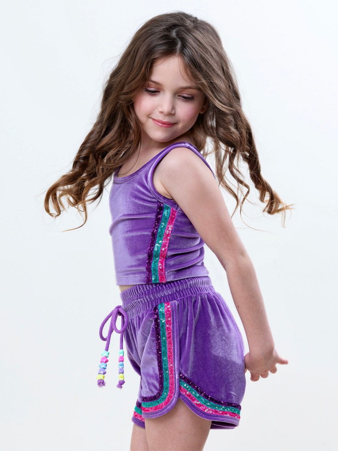 Girl wearing mermaid inspired purple velour short set with sparkle trim