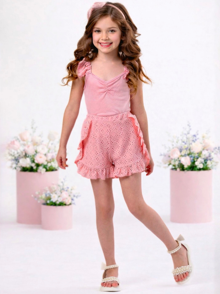 Girl wearing coral eyelet short set with ruffle shorts for spring outfit
