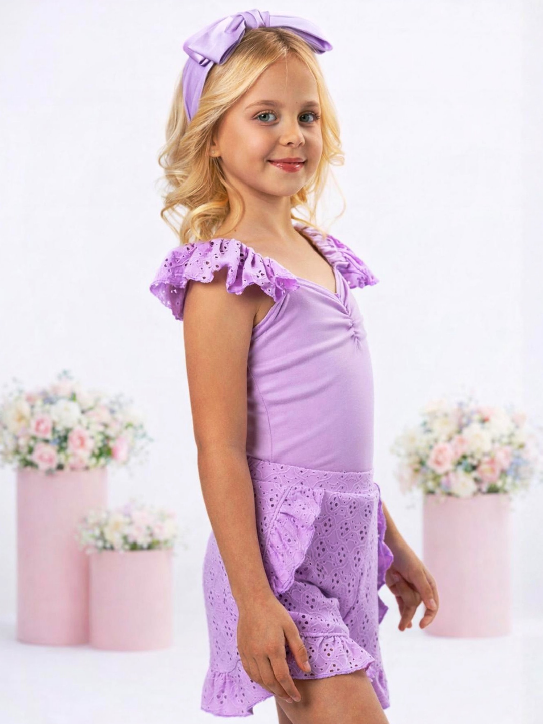 Girl in lavender summer set with ruched top and embroidered eyelet shorts