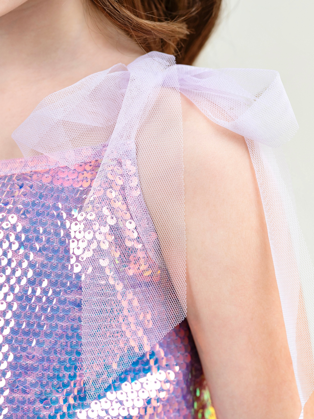Girl wearing iridescent sequin skirt set with shimmer top for party outfit