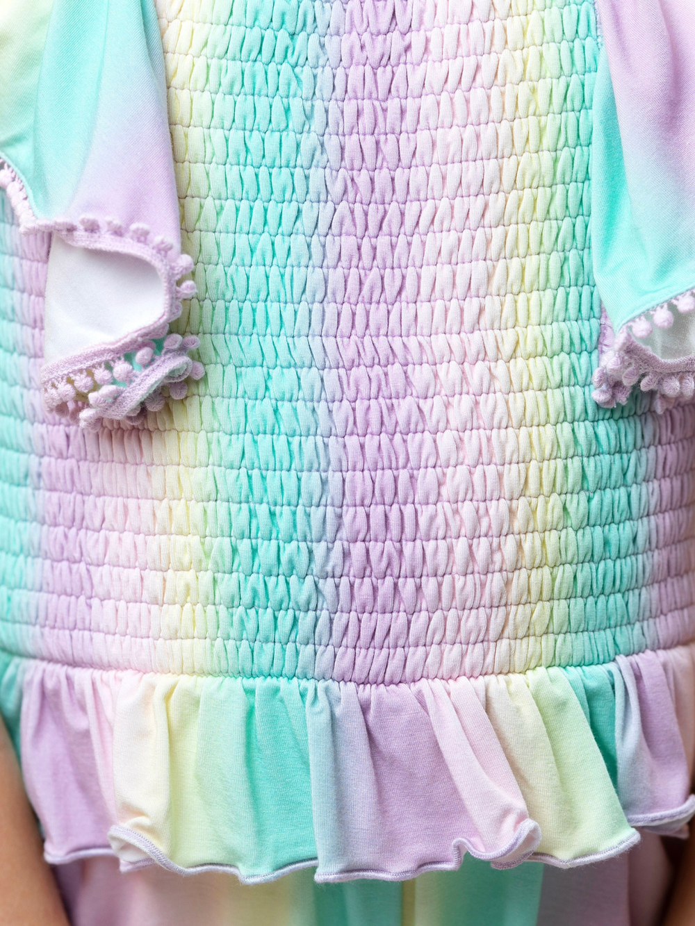 girls rainbow smocked romper with pom pom sleeves