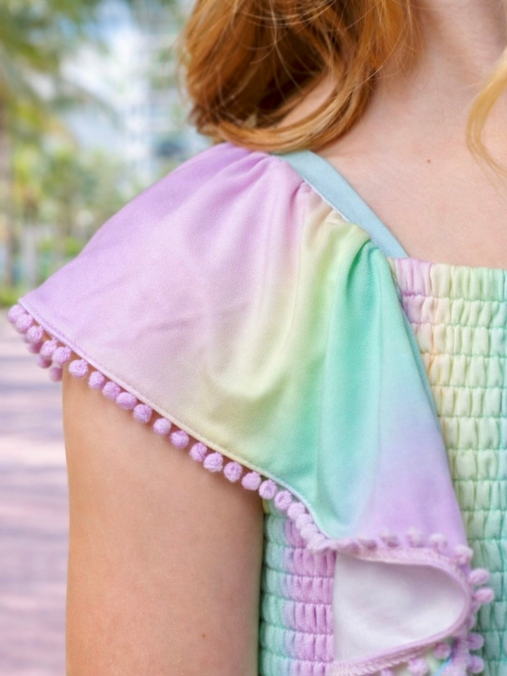 girls rainbow smocked romper with pom pom sleeves