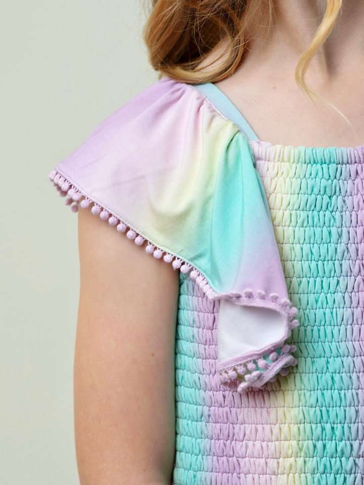 girls rainbow smocked romper with pom pom sleeves