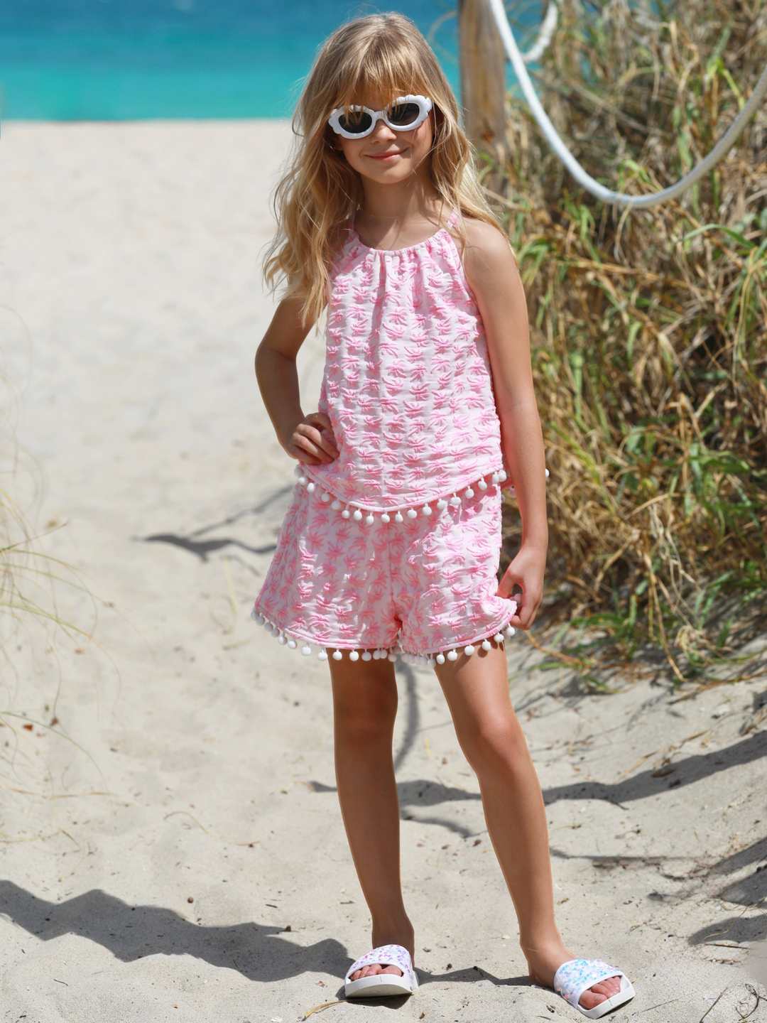 cute girls outfit pink sleeveless top and shorts with pom trim