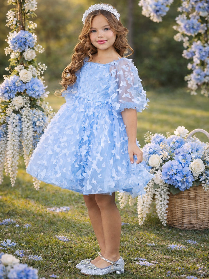 Girls blue butterfly dress styled for spring wedding