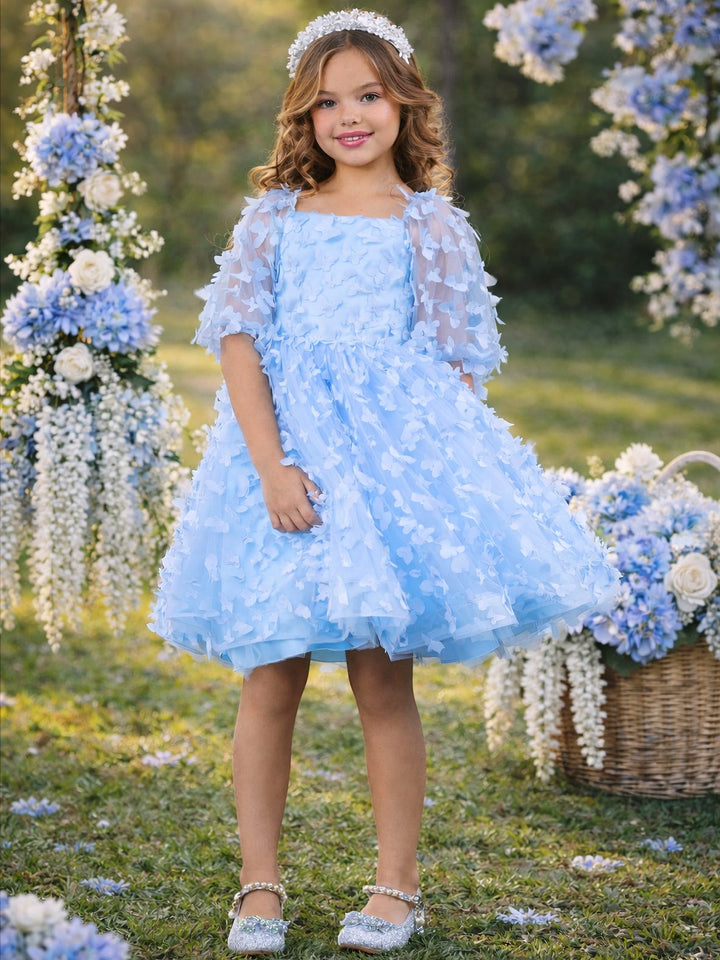 Girls blue butterfly dress styled for spring wedding