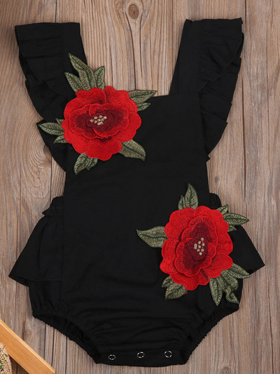 Baby little onesie has big red flower appliques and ties at the back for easy slip-on black