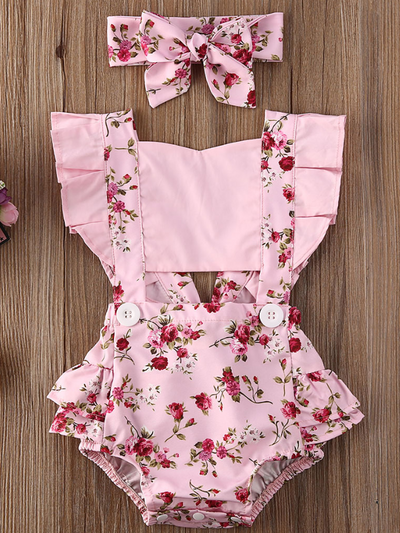Baby overall style onesie with ruffles on the bum that ties in the back and a matching headband pink