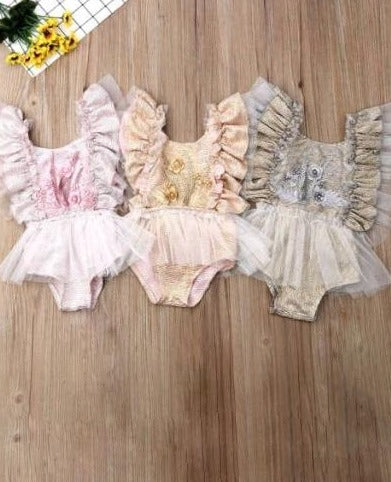 Baby ruffled tutu onesie has a cute flower applique and is a pullover style
