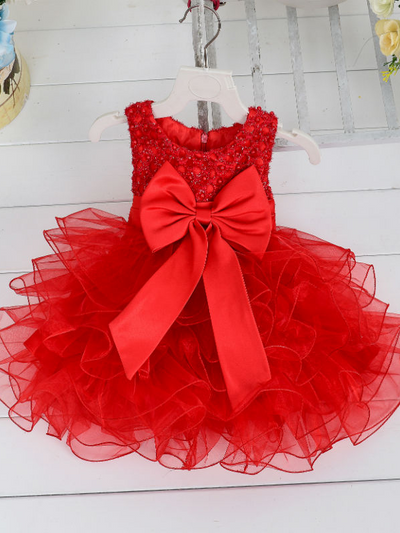 Baby princess dress has a satin bodice with pearl details, a bow belt at the waist, and a layered tulle skirt -red