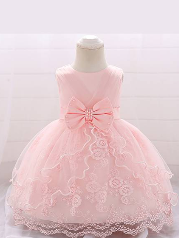 Baby dress has a tulle overlay with a multi-layer skirt, bow detail at the waist-pink