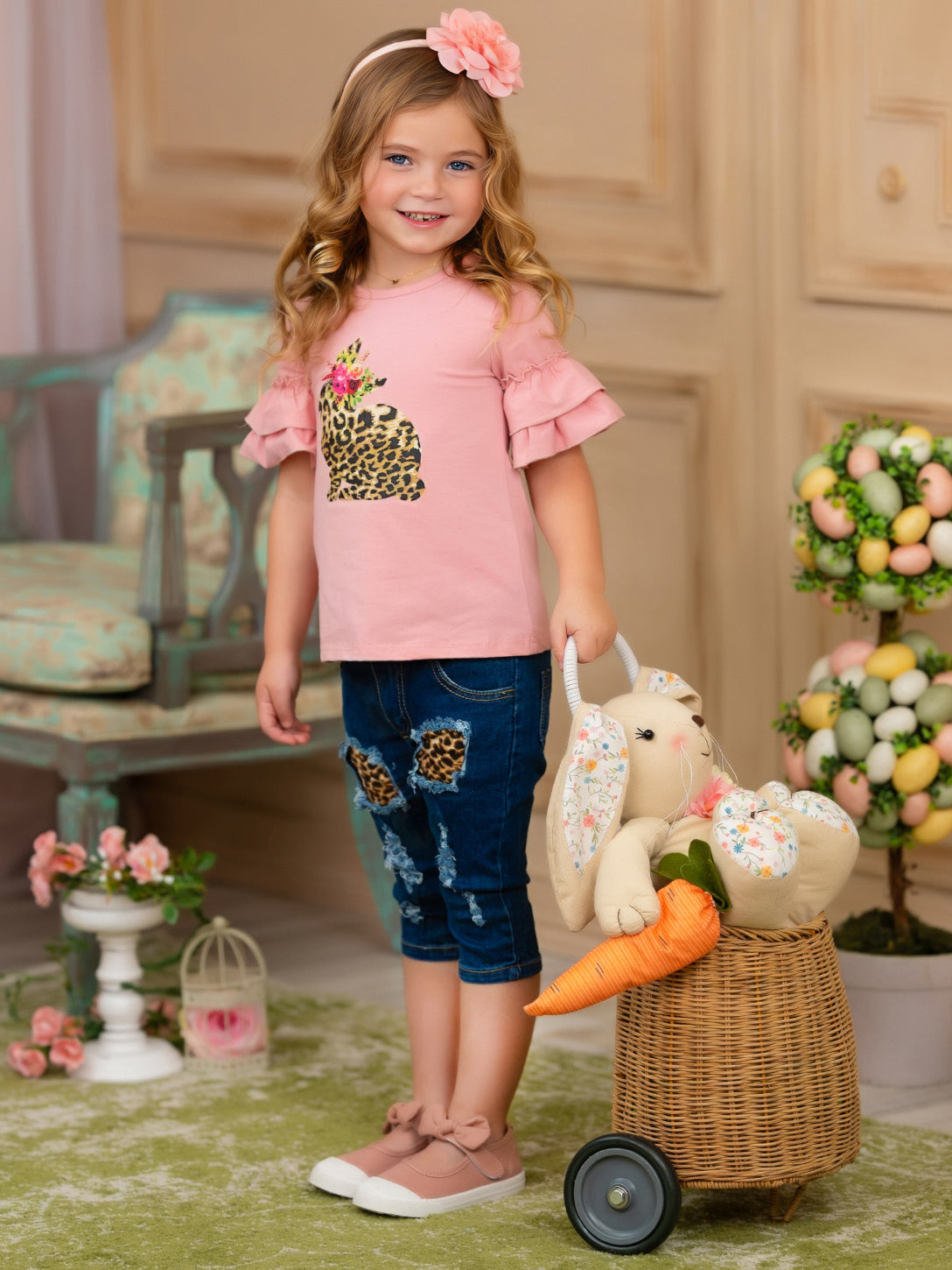 Girls Easter-themed set features a ruffled sleeve top with a leopard print bunny graphic and patched denim capris with a leopard print sash belt for 2T to 10Y toddlers and girls