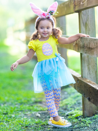 Girls Easter-theme set features ruffle short sleeves, egg applique, and two-tier sequin tulle hem with stretchy zigzag striped capris-length leggings for 2T to 10Y for toddlers and girls