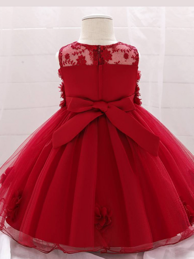 The dress has a bodice with flower applique and tulle skirt