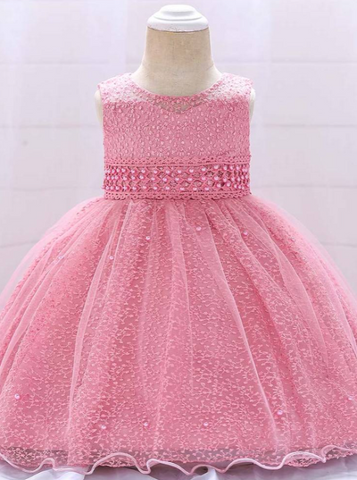 Baby dress has a tulle overlay with embroidered stars with an attached pearl belt and bow at the back-pink