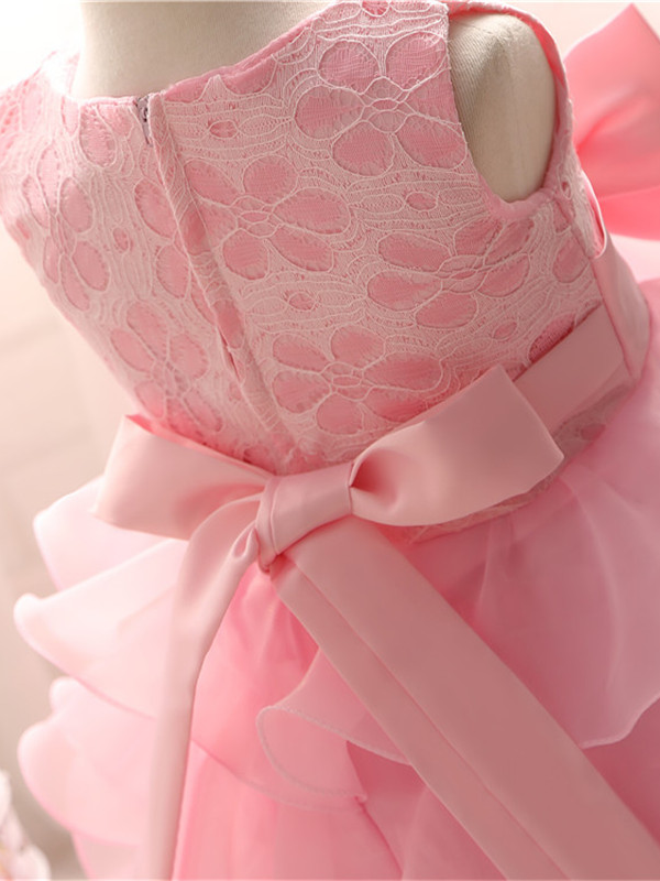 Baby princess dress has a floral lace bodice with rhinestone details, a bow belt at the waist, and a multi-layered tulle skirt-pink