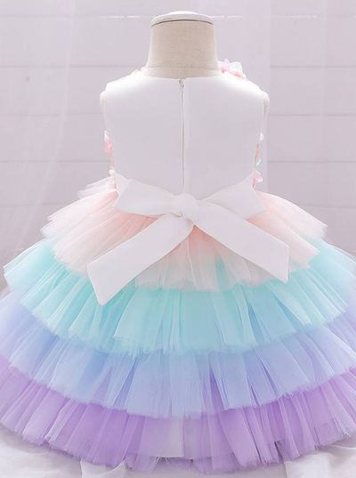 Baby Spring tulle dress' bodice has a delicate flower applique in tulle, has a multicolor layered skirt and bow at the back