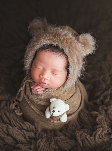 Baby set features a knitted shawl - wrap with a faux fur cap with ears and a little doll brown