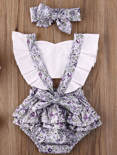 Baby overall style onesie with ruffles on the bum that ties in the back and a matching headband lilac