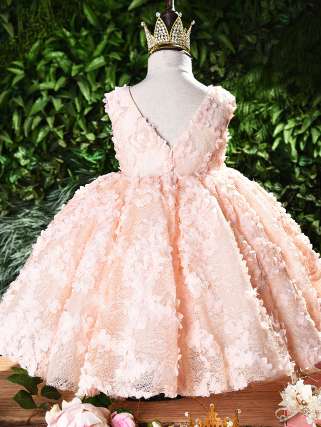 Baby tulle dress' bodice has a delicate flower applique in tulle, has a multicolor layered skirt and bow at the back