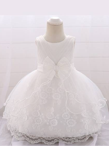 Baby dress has a tulle overlay with a multi-layer skirt, bow detail at the waist-white