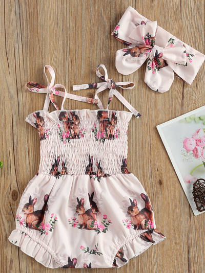 Baby pink onesie with bunny prints and a stretchy bodice with adjustable shoulder straps with a matching headband