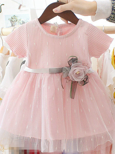 Baby Spring dress has a tulle overlay and a satin belt with a flower applique Pink