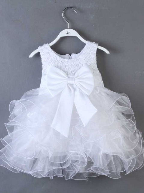 Baby princess dress has a satin bodice with pearl details, a bow belt at the waist, and a layered tulle skirt -white