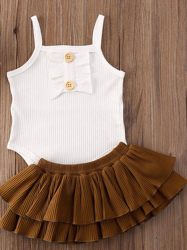 Baby onesie bodysuit has a cute ruffle detail and front buttons and spaghetti straps and skirted bloomers