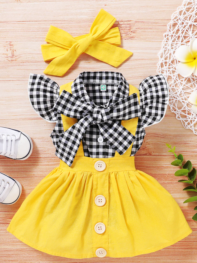 Baby set features a plaid top with front buttons and bow at the color, a skirt with cute suspenders, and a matching headband