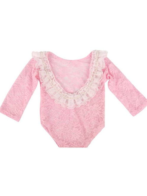 Baby lace onesie has an open back with white lace ruffles  pink