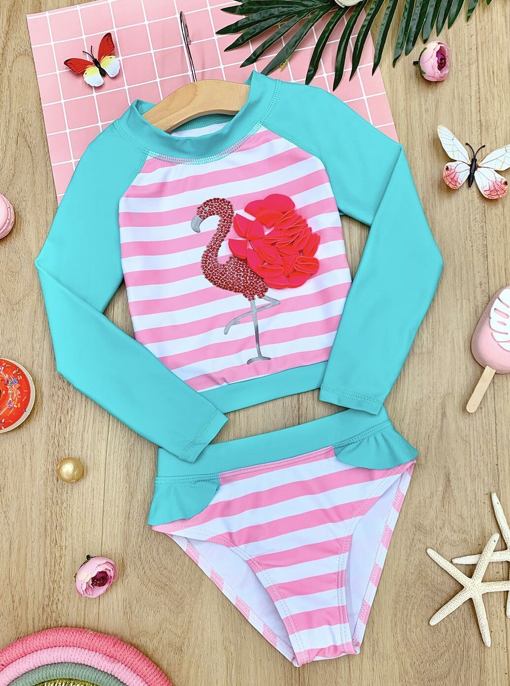 Two-piece rash guard swimsuit features long raglan sleeve top with flamingo applique and matching bikini bottoms 4T to 8Y for toddlers and girls