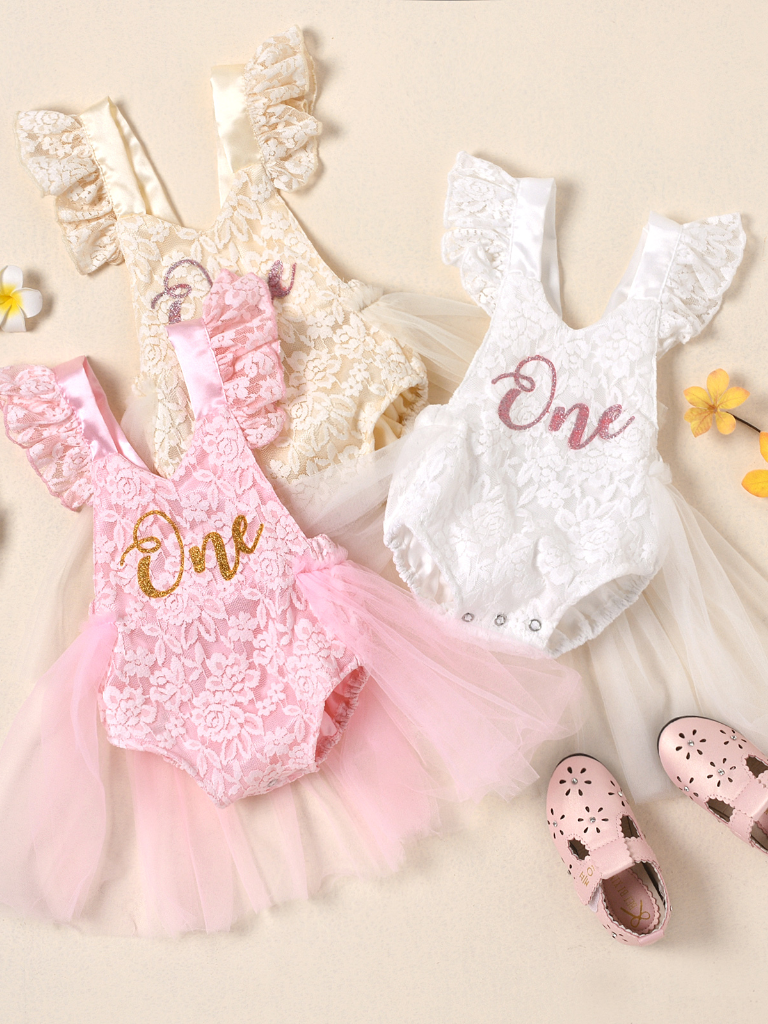 Baby lace overall onesie that ties at the back with tulle train, little ruffles at the shoulder, and a gold "One" printed on the bodice