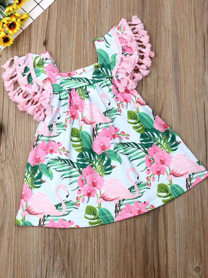 Baby apron style dress has a flamingo and tropical leaf print, a cute tasseled hem at the ruffled shoulders add a little extra-extra 