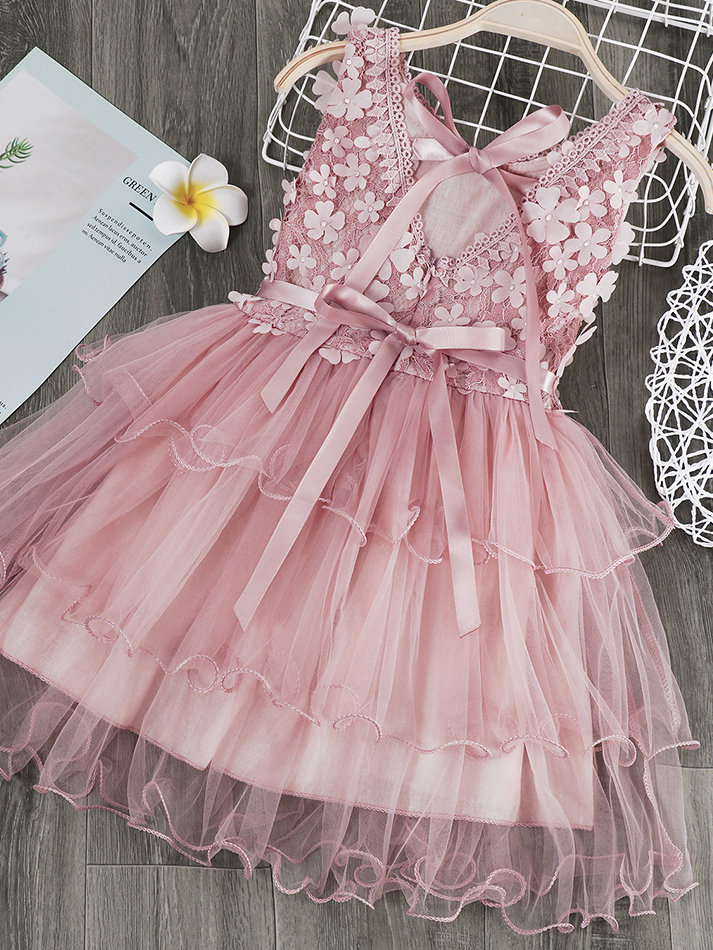 Girls  tulle dress features a bodice with flower applique and multi-layered skirt, delicate bow details on the back