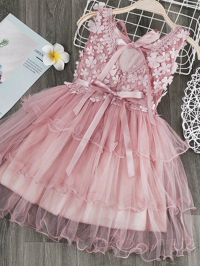 Girls  tulle dress features a bodice with flower applique and multi-layered skirt, delicate bow details on the back