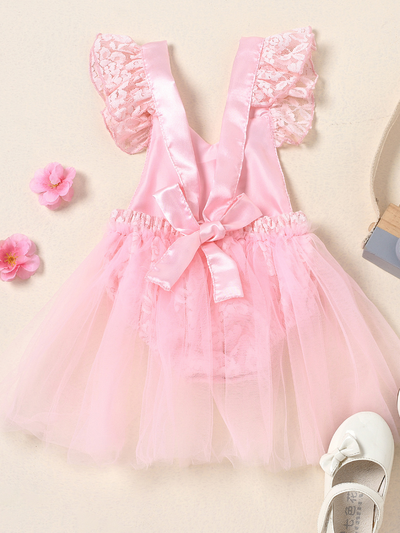 Baby lace overall onesie that ties at the back with tulle train, little ruffles at the shoulder, and a gold "One" printed on the bodice