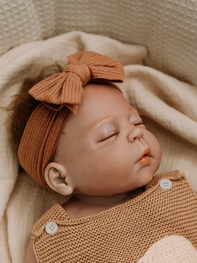 Baby wearing bow headband  brown