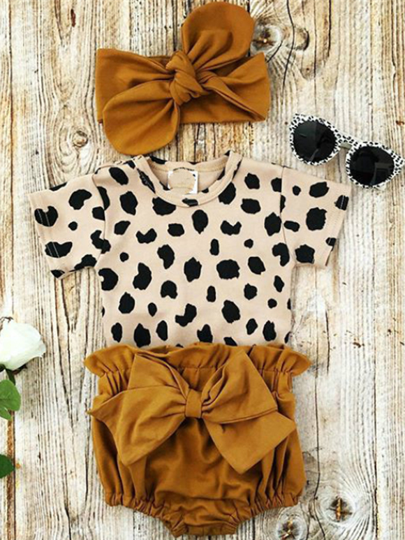 Baby set features a short-sleeved onesie with animal print, bloomer shorts with a bow, and matching headbands